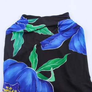 Women's floral print dress with blue flowers and green leaves on black fabric