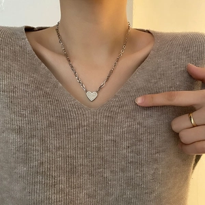 Minimalist silver heart pendant necklace in titanium steel on a female model
