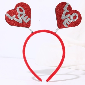 Detail of red sequin heart headband with silver LOVE lettering on metal springs