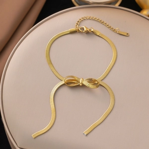 Close-up of 18K gold plated bow pendant snake chain bracelet with K.S.STEEL tag