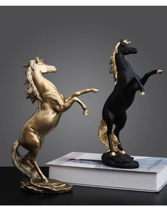 Artistic golden and black jumping horse statues with rock base for home decor