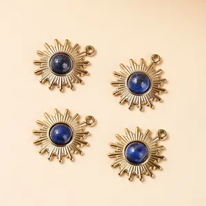 Set of four gold-plated sunburst charms with inlaid natural blue lapis lazuli stones