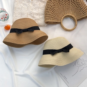 French style straw sun hats with elegant black bow ribbons for seaside summer vacations