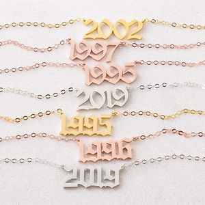 Personalized stainless steel year necklaces in gold, rose gold, and silver finishes