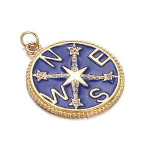 Detailed close-up of golden compass pendant with blue enamel and sparkling star center