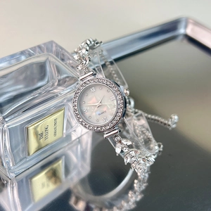 Elegant women's quartz watch with silver diamond bracelet and mother-of-pearl dial
