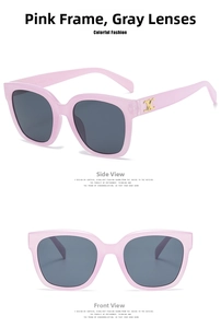 Detail of pink vintage square sunglasses featuring golden metal accents on the temples