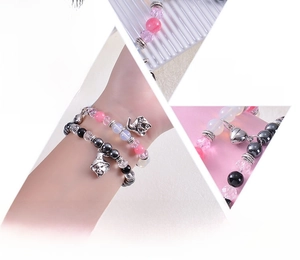 Detailed macro view of natural stone beads and cute wizard hat charm on elastic bracelet