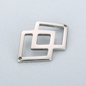 Macro shot of interlocking geometric diamond charms in polished silver stainless steel