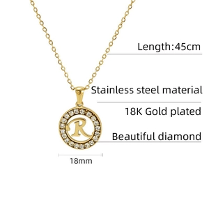 Detailed view of 18K gold plated stainless steel letter R pendant with sparkling diamonds
