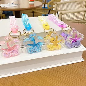 Set of four cherry blossom liquid quicksand keychains with colorful sea stars and sequins