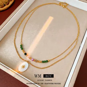 Vintage double layer gold necklace with colorful beads and sunburst oval pendant