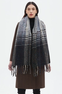 Close-up of a thick winter scarf with gradient plaid pattern and long tassel details