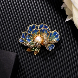 Exquisite peony flower brooch with blue enamel petals and a central pearl detail