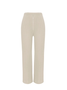 Detail of high-waist beige ribbed knit wide-leg pants with vertical texture fabric