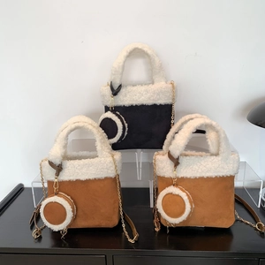 Fleece-lined suede bucket bag in black and camel colors with chain strap for women