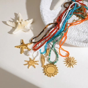 Close-up of bohemian colorful beaded necklaces with starfish and sun pendants