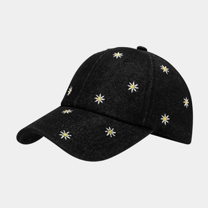 Denim baseball cap featuring all-over daisy embroidery on a classic black wash fabric