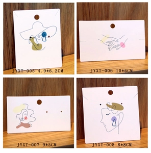 Collage of four minimalist jewelry cards with abstract line art on a wood surface