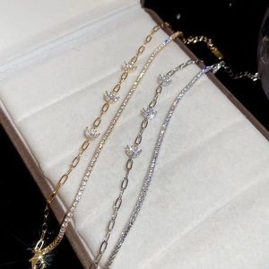 Detail of 18k gold and silver plated tennis bracelets with sparkling zircon stones