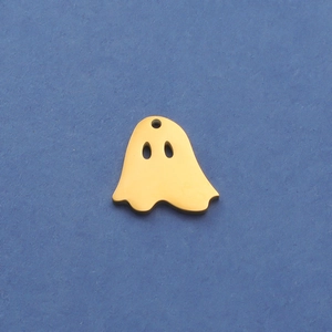 Close-up of a mirror-polished gold ghost pendant charm for Halloween DIY jewelry making