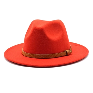 Close-up of red fedora hat with brown snake-patterned leather band and metal buckle