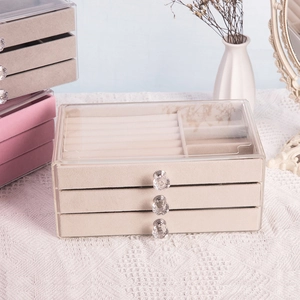 Three-layer acrylic jewelry storage box with beige velvet drawers and crystal handles