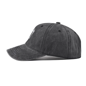 Detail view of washed cotton baseball cap showing stitching and coconut tree embroidery