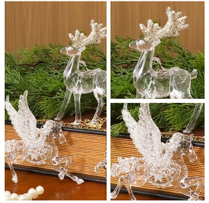 Detail of transparent acrylic reindeer and pegasus ornaments with silver glitter accents