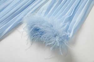 Détail du tissu plissé bleu clair avec garniture en fourrure de renard et perles de luxe