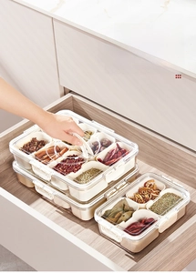 Divided kitchen spice storage box set organized in a modern wooden drawer