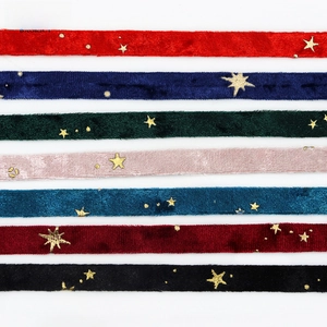 Flat lay of colorful gold-stamped star velvet ribbons for DIY hair accessories