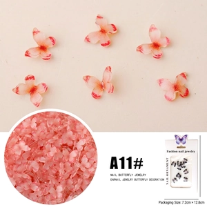 Detailed view of pink 3D butterfly nail art charms with gradient resin and packaging