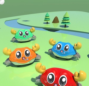 Close-up of four colorful cartoon crab inertia toys in green, orange, blue, and red