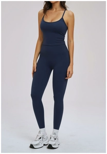 Detail of dark blue yoga set featuring a strappy racerback tank and high waist leggings