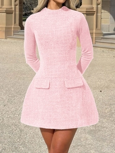 Close-up of pink tweed long-sleeve dress fabric texture with front pocket detail