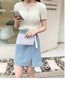Street style shot featuring a white faux crocodile skin clutch with blue slit midi skirt