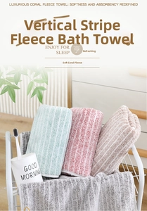 Close-up of vertical stripe coral fleece towel set in four pastel colors inside a wire basket