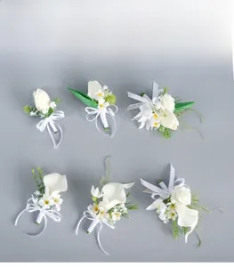 Close-up of white PU calla lily and tulip wedding boutonniere with silk ribbon