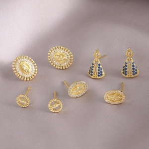 Religious gold stud earring set with zircon inlays and blue stones on fabric back