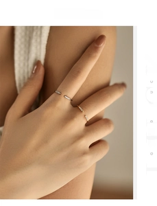 Close-up of elegant minimalist open rings in silver and gold finish with micro-pavé crystals