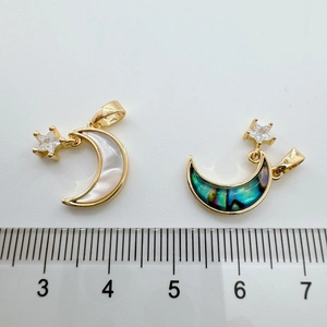 Detailed size view of 18k gold moon and star pendants with shell and abalone inlay