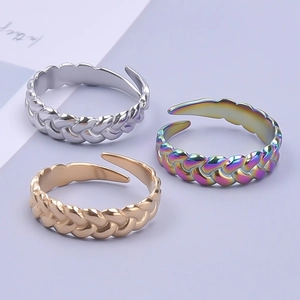 Three adjustable braided stainless steel rings in silver, gold, and rainbow finishes