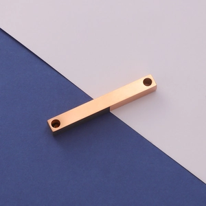Macro shot of rose gold stainless steel rectangle pendant with dual mounting holes