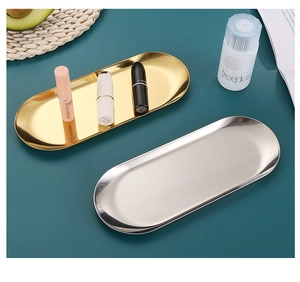 Top view of gold and silver stainless steel oval trays for jewelry and cosmetics storage