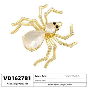 Detailed view of a gold brass spider pendant with sparkling crystals and size measurements