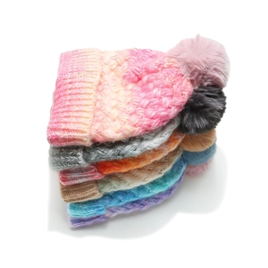 Chunky knit pom-pom beanie with gradient tie-dye pattern and warm fleece lining