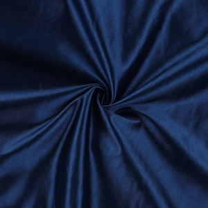 Macro shot of dark blue satin fabric with deep pleats showing silk texture and glossy finish