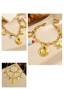Close-up of bohemian gold link jewelry set with colorful beads and flower charms