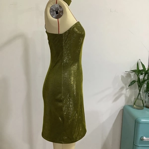 Detail of green sequin bodycon party dress with metallic glitter on a mannequin